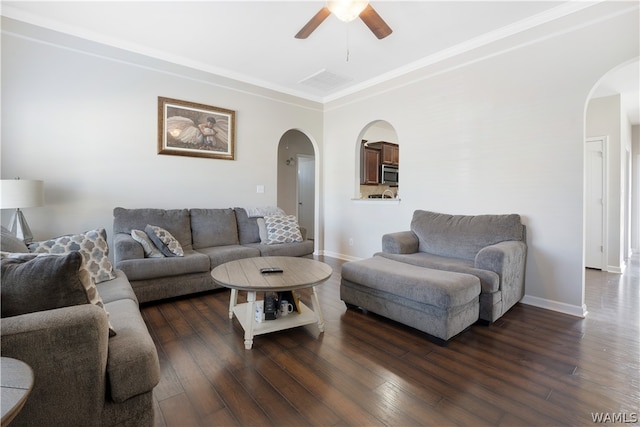 living room with ceiling fan, dark hardwood / wood-style floors, and ornamental molding