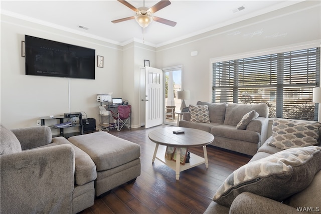 living room with dark hardwood / wood-style flooring, ceiling fan, and crown molding