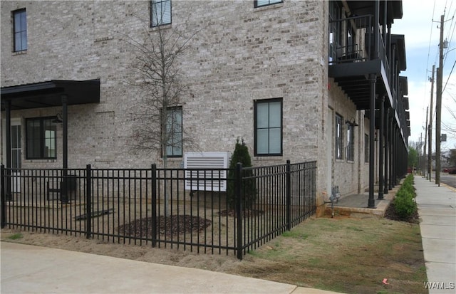 817 Gene Stallings Ave, Tuscaloosa, AL 35401 - view of property exterior with a fenced front yard, stone siding, and brick siding