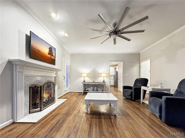 1851 Russet Woods Ln, Hoover, AL 35244 - living room with wood finished floors, ceiling fan, ornamental molding, a premium fireplace, and baseboards
