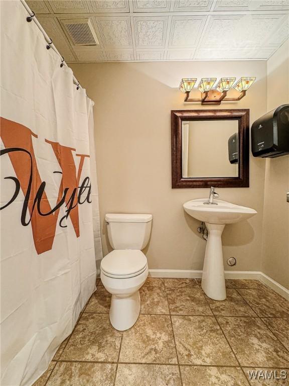 1851 Russet Woods Ln, Hoover, AL 35244 - full bath with toilet, baseboards, curtained shower, and tile patterned floors