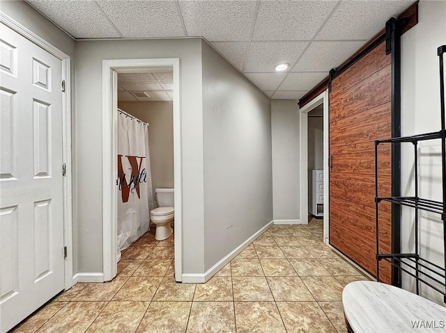 1851 Russet Woods Ln, Hoover, AL 35244 - bathroom with toilet, tile patterned floors, baseboards, a drop ceiling, and a shower with curtain
