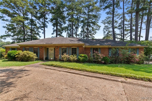 ranch-style home with a front lawn