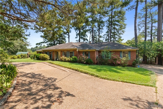 ranch-style house with a front lawn