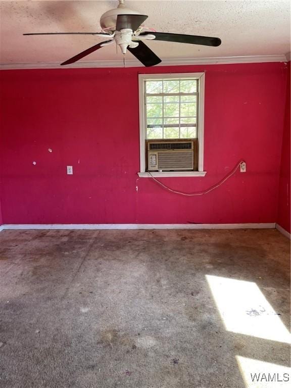 empty room with a ceiling fan, cooling unit, a textured ceiling, baseboards, and ornamental molding