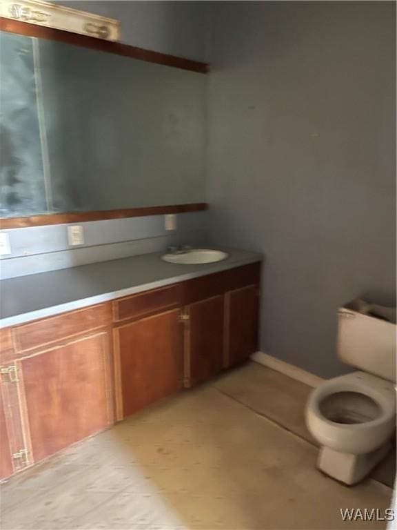 bathroom featuring toilet and vanity