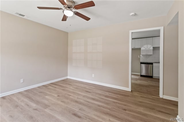 unfurnished room with ceiling fan and wood-type flooring