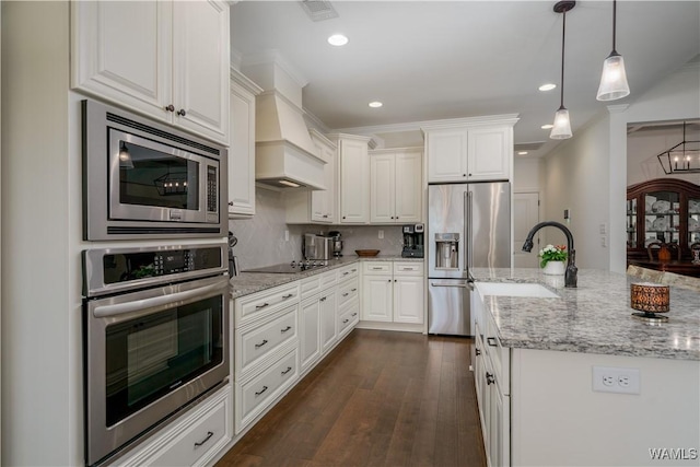 kitchen featuring a sink, white cabinetry, appliances with stainless steel finishes, custom exhaust hood, and dark wood-style floors