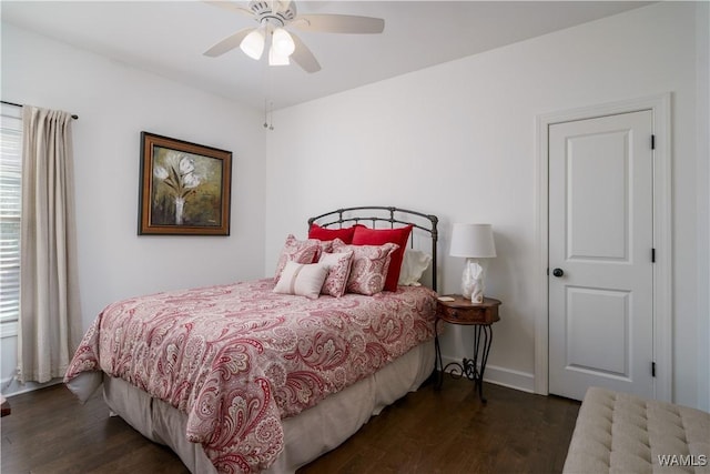 bedroom with ceiling fan, wood finished floors, and baseboards