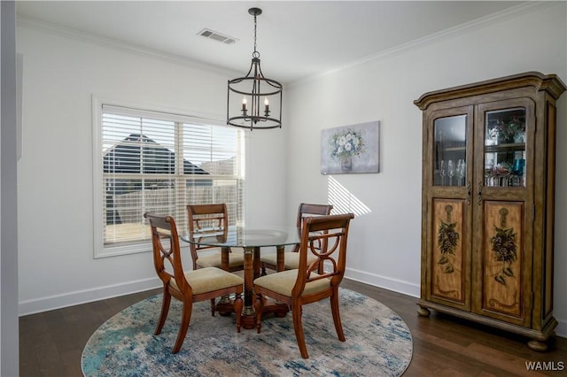 dining area with dark wood-type flooring, visible vents, crown molding, and baseboards