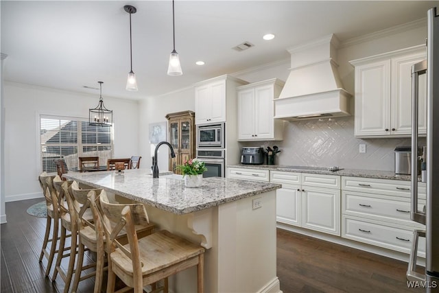 kitchen featuring appliances with stainless steel finishes, dark wood finished floors, a sink, and custom exhaust hood