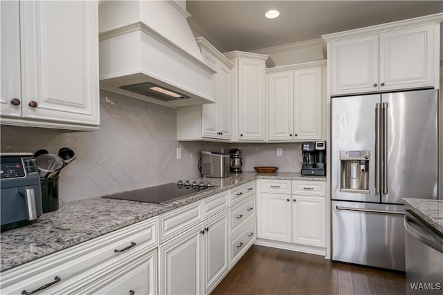 kitchen with stainless steel appliances, dark wood finished floors, white cabinets, and custom range hood