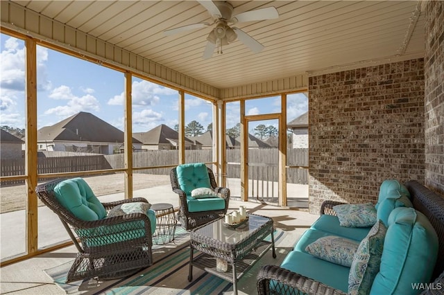 sunroom / solarium featuring a residential view and ceiling fan