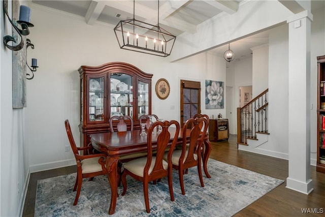 dining room featuring baseboards, coffered ceiling, stairway, wood finished floors, and beam ceiling