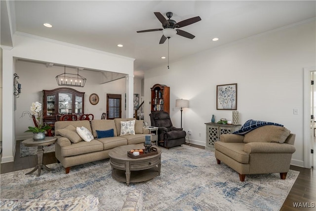 living room featuring ornamental molding, recessed lighting, wood finished floors, and ornate columns