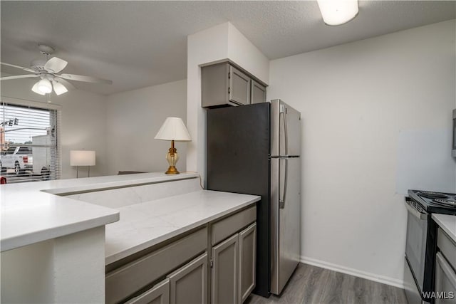 1009 12th St Unit 3, Tuscaloosa, AL 35401 - kitchen featuring electric stove, freestanding refrigerator, gray cabinets, wood finished floors, and a ceiling fan