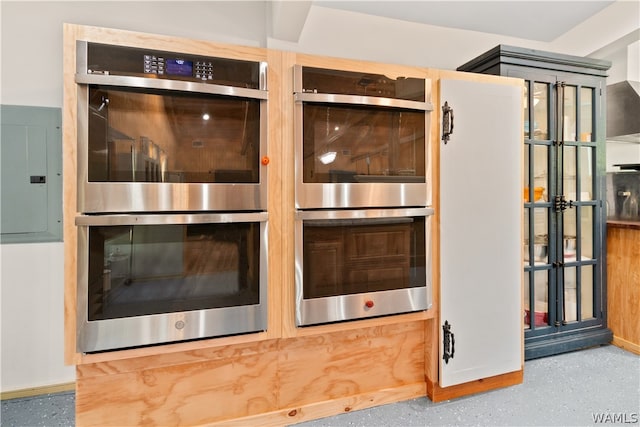 interior details featuring electric panel and double oven