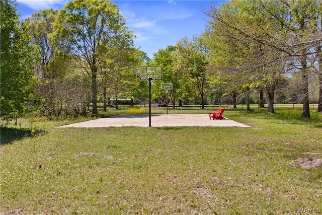 view of basketball court with a lawn