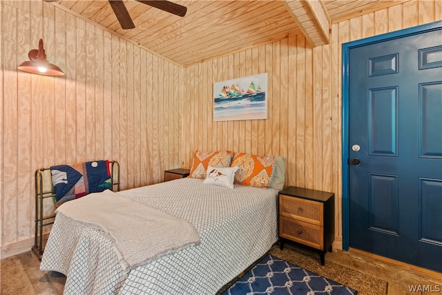 bedroom featuring ceiling fan, wooden ceiling, and wood walls