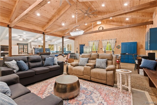 living room featuring beamed ceiling, wooden ceiling, and a healthy amount of sunlight