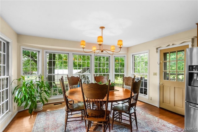 sunroom featuring an inviting chandelier