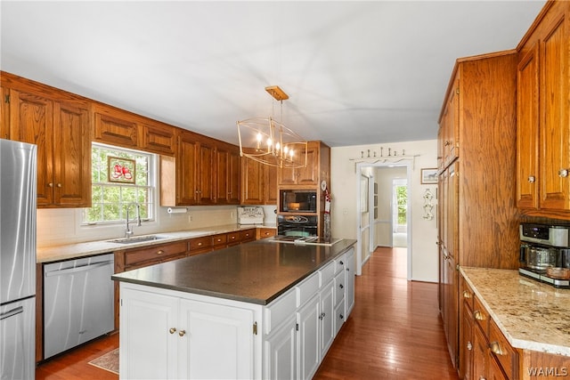 kitchen featuring black appliances, white cabinets, sink, and hardwood / wood-style floors