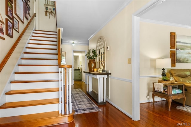 stairs featuring hardwood / wood-style flooring and ornamental molding