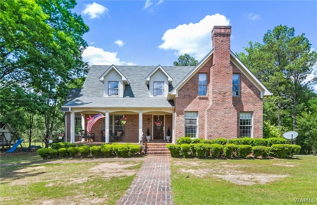 cape cod home featuring a front yard and a porch