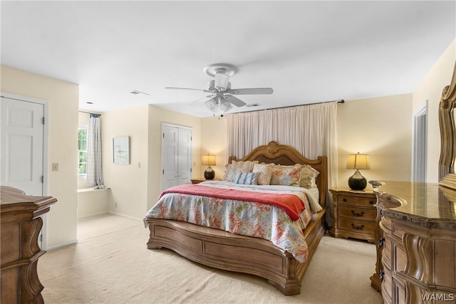 carpeted bedroom featuring ceiling fan and a closet