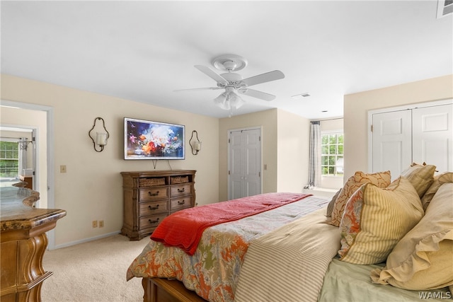 bedroom with ceiling fan and light carpet