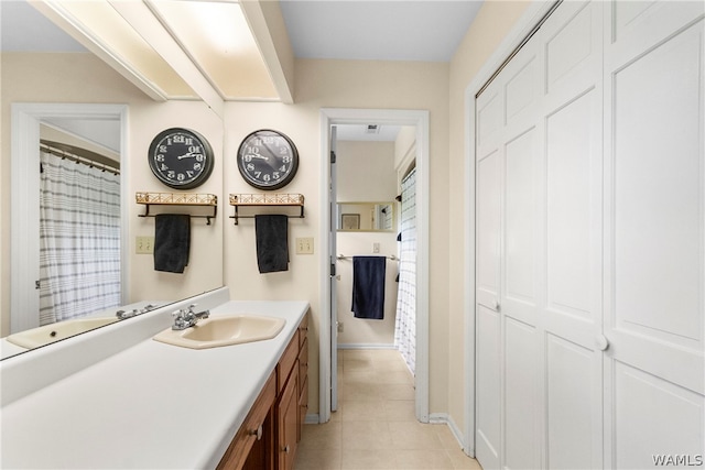 bathroom with tile patterned flooring and vanity