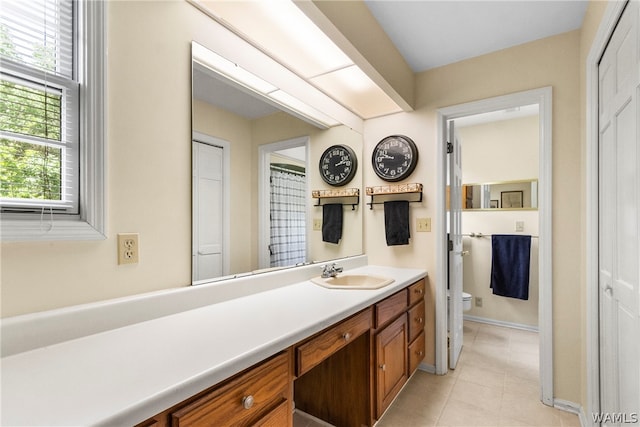 bathroom featuring tile patterned floors, vanity, and toilet