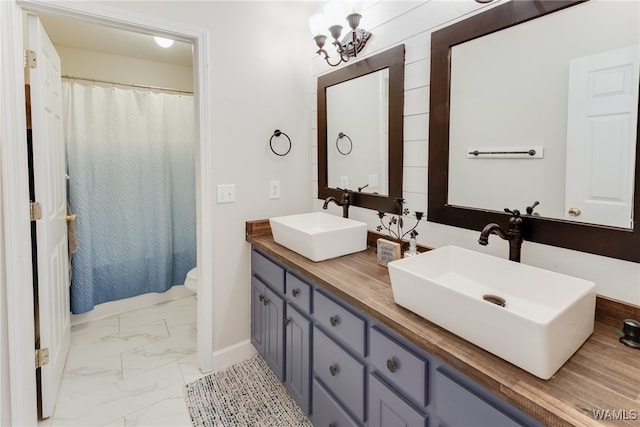 bathroom featuring vanity and a chandelier