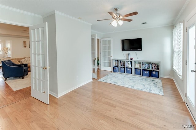 living room featuring light hardwood / wood-style flooring, ornamental molding, french doors, and ceiling fan