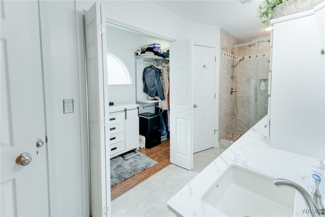 bathroom with walk in shower and vanity