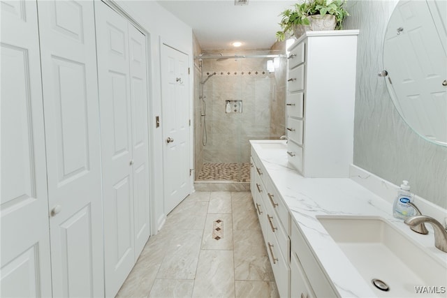 bathroom with vanity and a shower with shower door