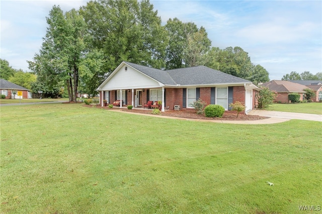 single story home featuring a garage, a front yard, and covered porch