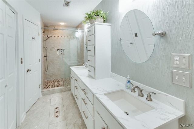 bathroom featuring vanity and a shower with shower door