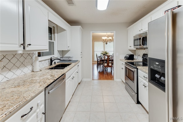 kitchen with white cabinetry, appliances with stainless steel finishes, and sink