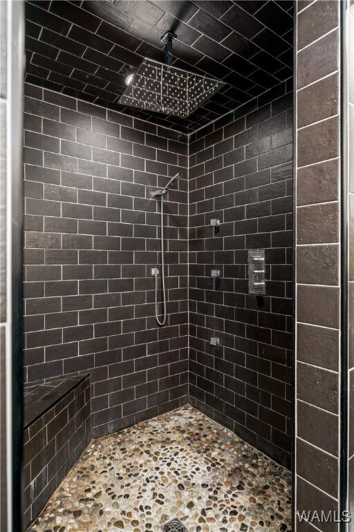 bathroom with tiled shower