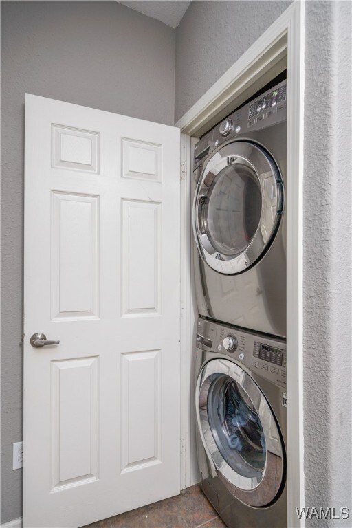 laundry area with stacked washer / drying machine