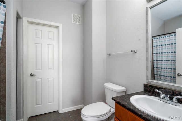 bathroom with tile patterned floors, vanity, toilet, and a shower with shower curtain