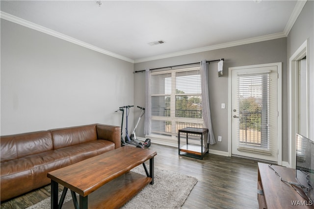 living room featuring dark hardwood / wood-style floors and crown molding