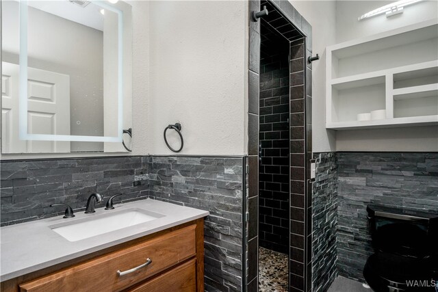 bathroom featuring vanity and a tile shower