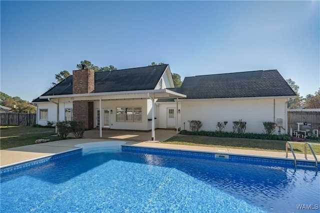 view of swimming pool featuring a lawn and a patio area