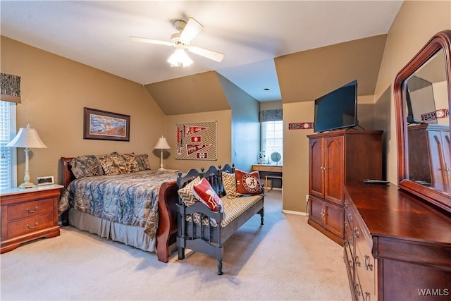 bedroom with ceiling fan, light carpet, and vaulted ceiling