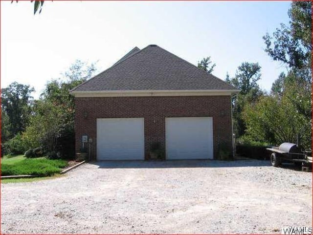 view of property exterior with an outbuilding and a garage