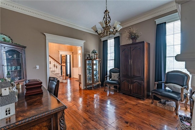 home office with crown molding, hardwood / wood-style floors, and a notable chandelier