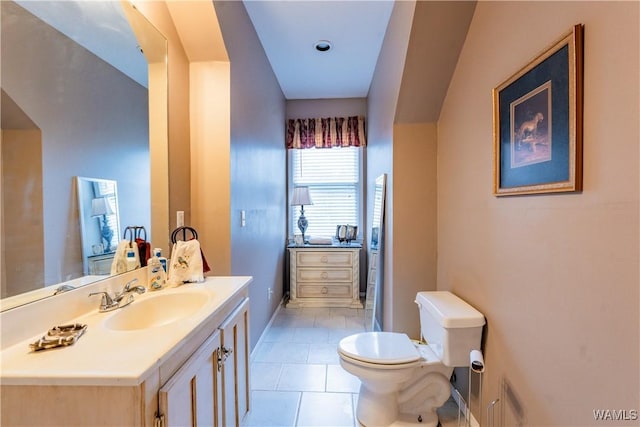 bathroom with toilet, tile patterned floors, and vanity