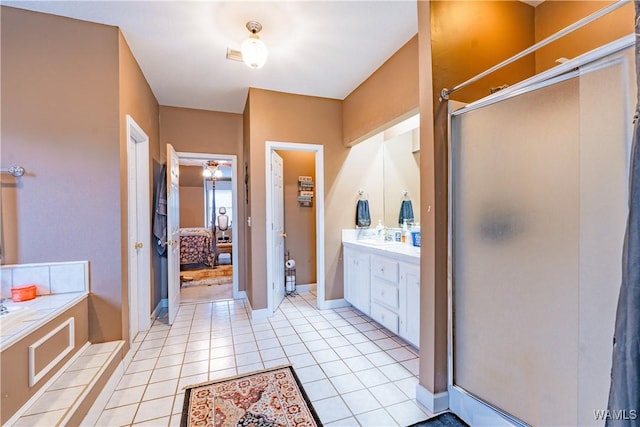 bathroom featuring a shower with shower door, tile patterned floors, and vanity